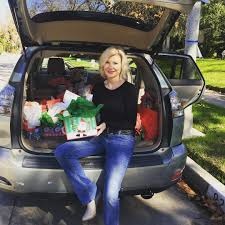 Beth packing up foods inside her car's trunk.
